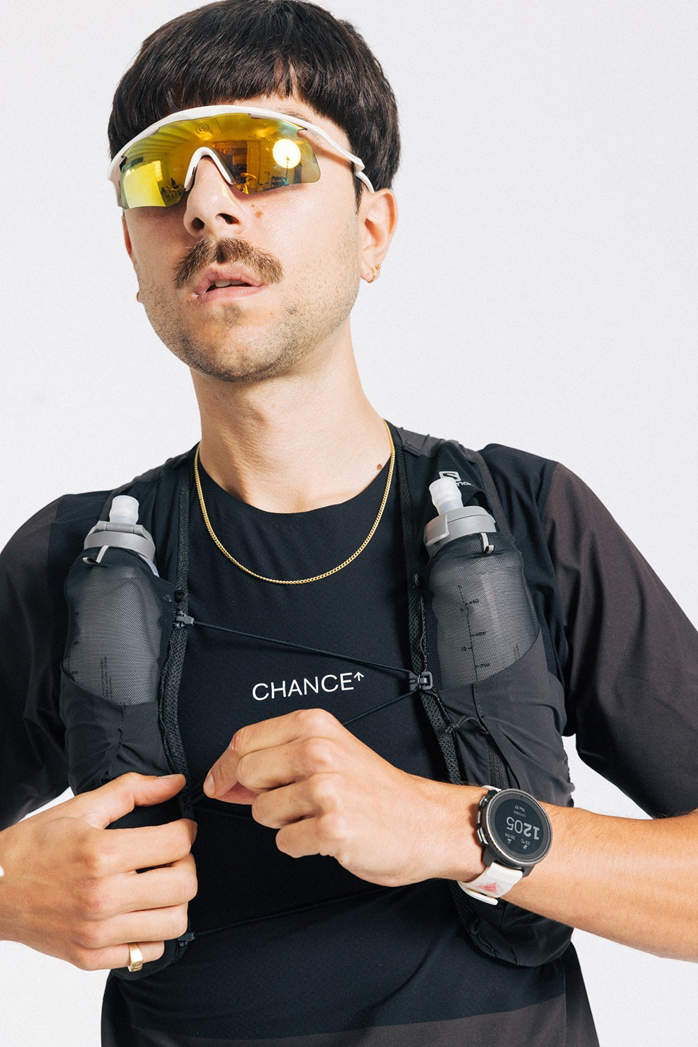 An ultra runner wears the Chance Ultra Tee in Black and Brown, with a white Chance logo mark on the chest.