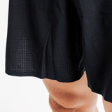 Close-up of the perforated fabric and split hem on the AROW Marathon Short v.2 in Black and White