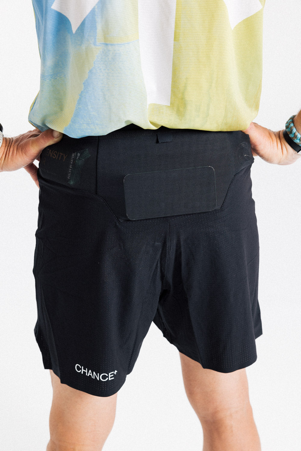 Back view of the AROW Marathon Short v.2 in Black and White, showing the rear waistband pocket and Chance logo
