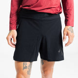 Close-up of the AROW Marathon Short v.2 in Black and Black worn with a red long sleeve top