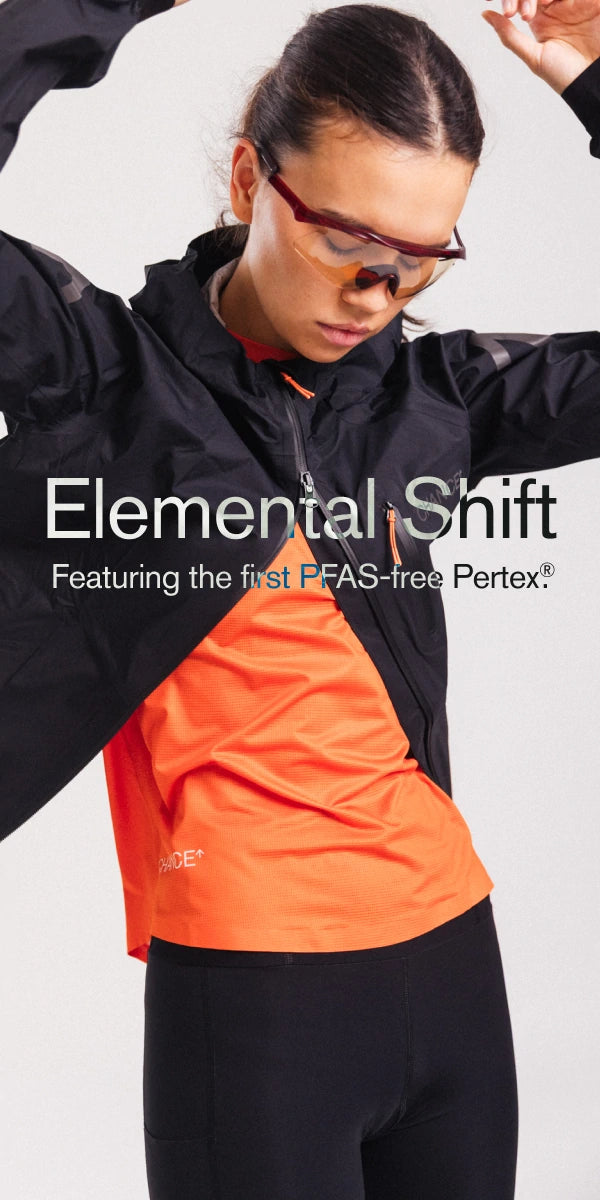 Person wearing a black and orange jacket with 'Elemental Shift' text on a white background